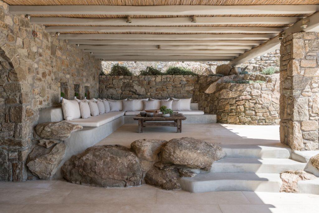 open-plan living room with natural stone interiors at Villa Nema, Mykonos